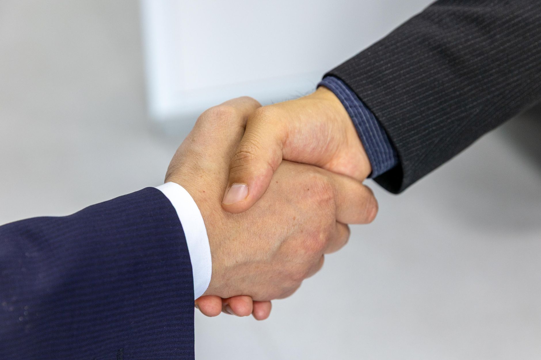 Professional handshake at a meeting — the trusted matching we're building the marketplace around
